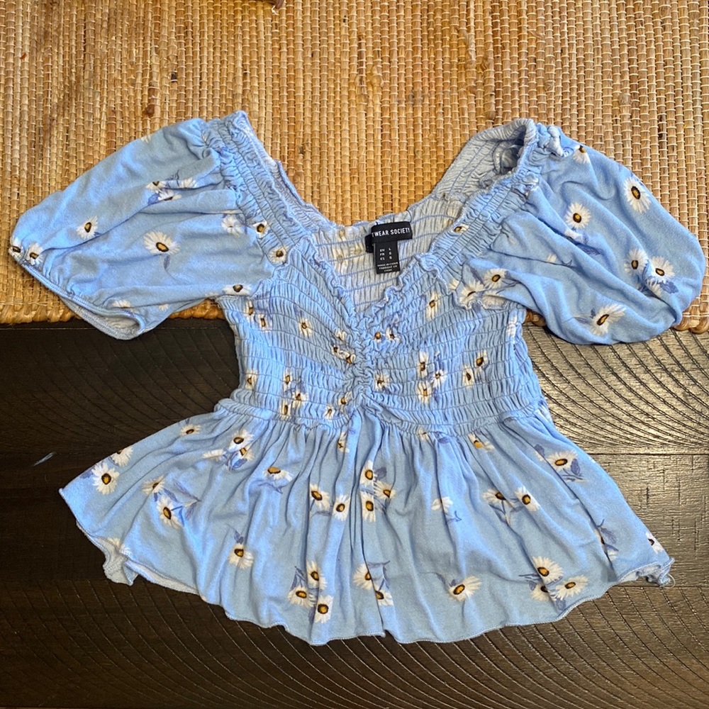 I am selling A Light blue cropped blouse with flowers on it. Very comfy